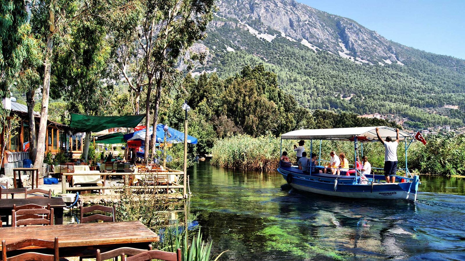 Riverside wooden houses and clear turquoise water in Akyaka, a Cittaslow town in Muğla