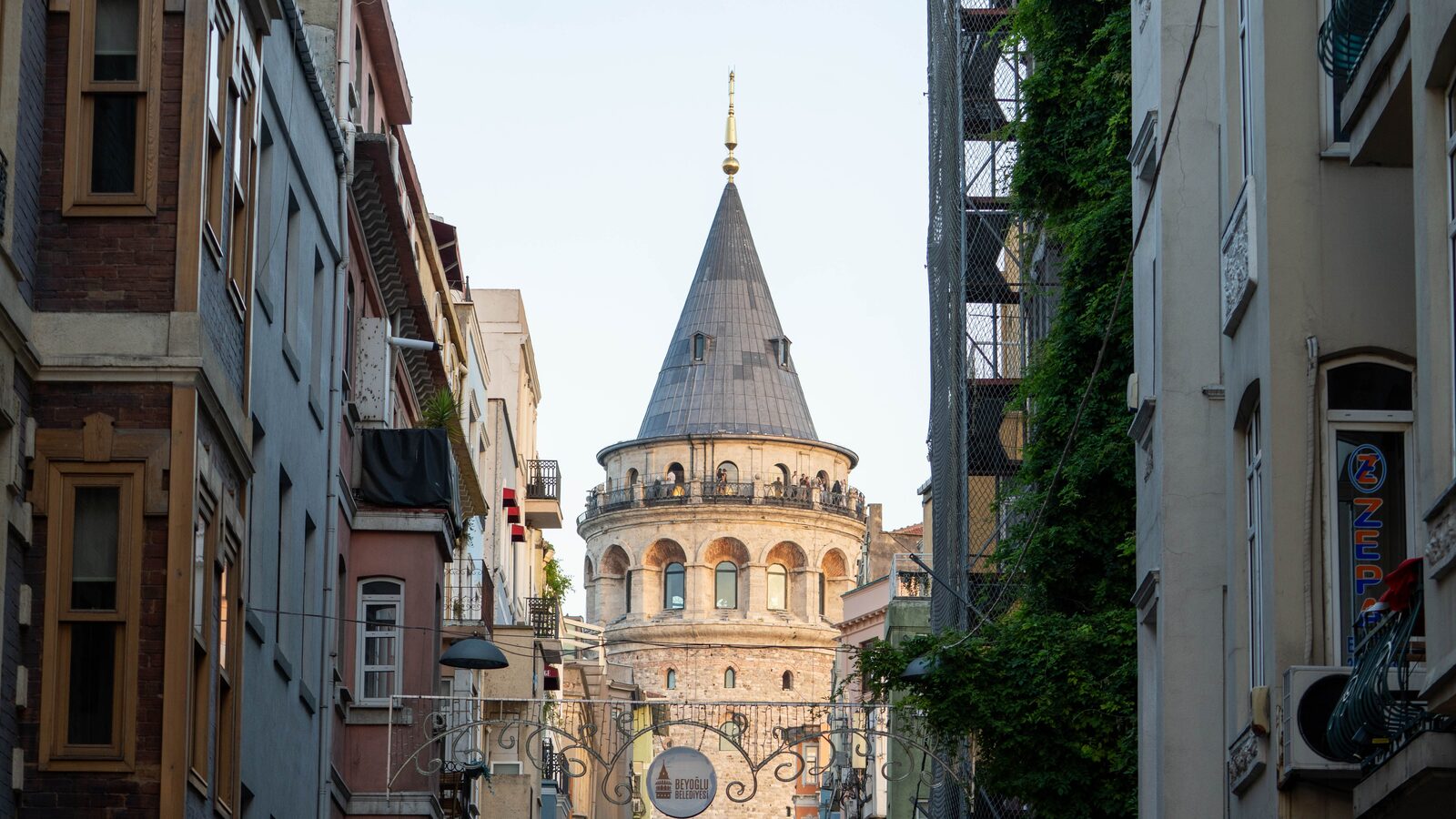 View over Istanbul rooftops towards Galata Tower, hub of a city connected by ferries, trams and metro