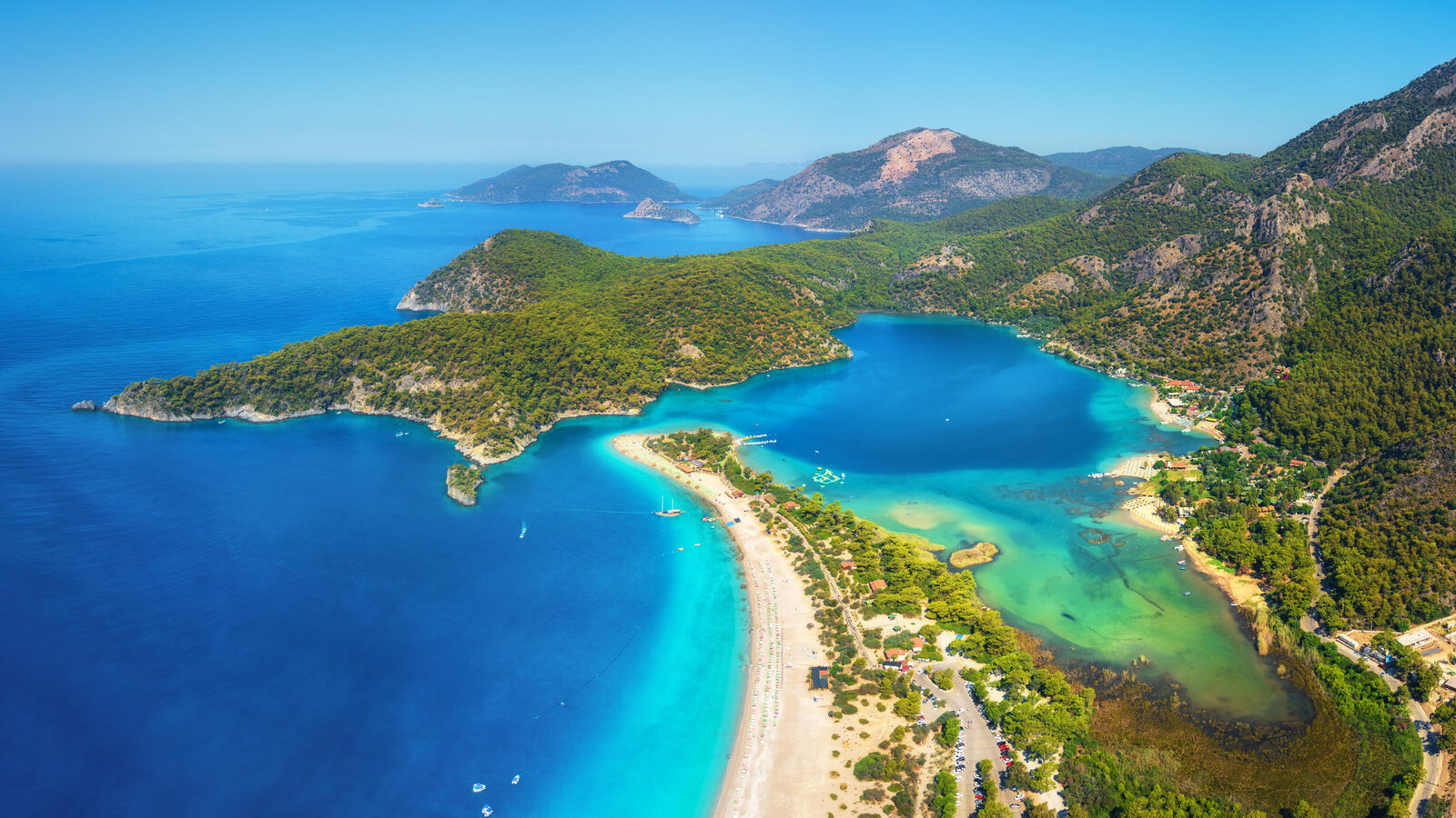 The famous Blue Lagoon of Ölüdeniz with turquoise water and pine-covered hills in summer
