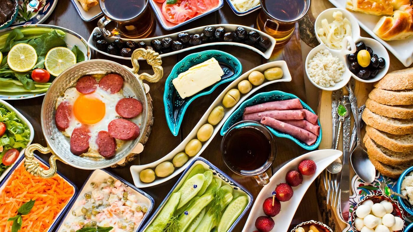 A traditional Turkish breakfast spread with cheeses, olives, jams, eggs and fresh bread